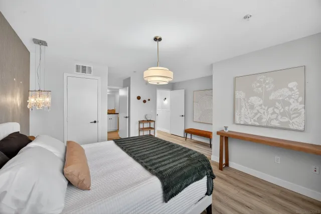 a bedroom with a bed and wooden floor