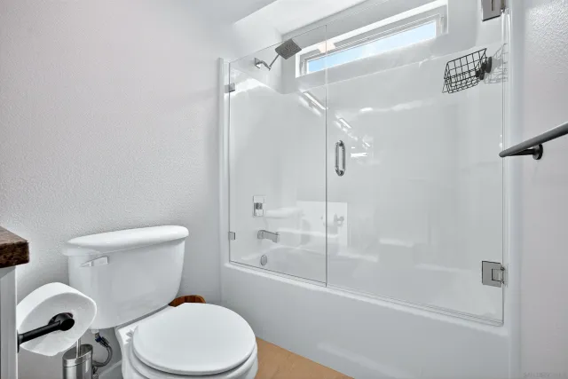a bathroom with a bathtub and shower