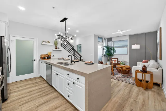 a kitchen with a sink and chandelier