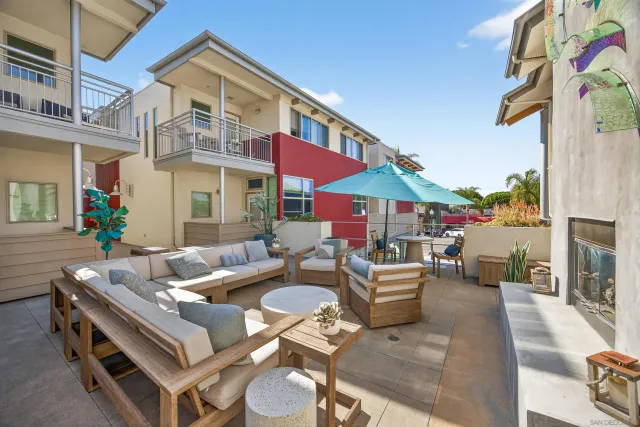 a balcony with table and chairs