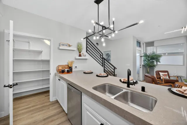 a kitchen with kitchen island granite countertop a sink appliances and cabinets