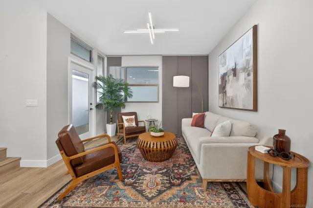 a living room with furniture and wooden floor