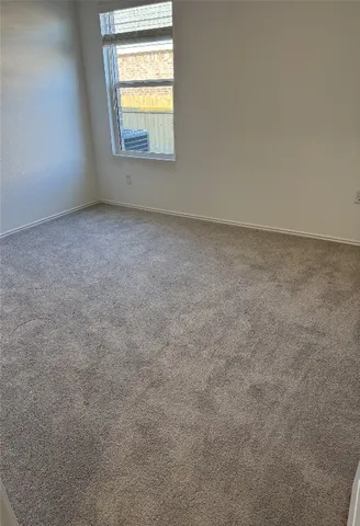 a view of an empty room and wooden floor