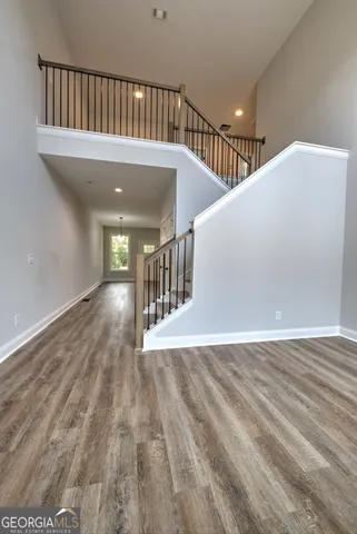 a view of a hallway with wooden floor
