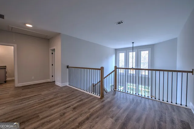 a view of a hallway with wooden floor
