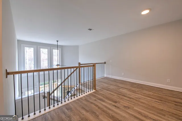 a view of hallway with wooden floor