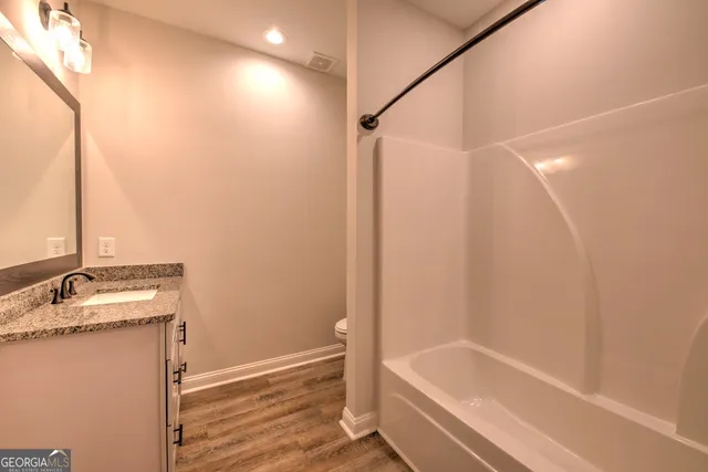 a bathroom with a tub and a sink