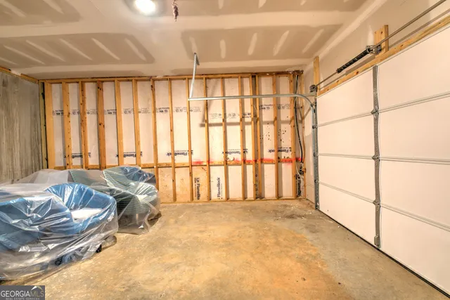 a bed sitting in a spacious bedroom next to a window