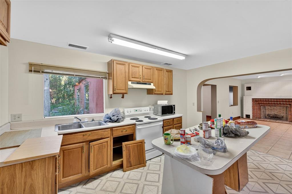 6346 Lost Trail Holiday, FL 34690 - Photo 20 of 55 a kitchen with a sink stove top oven and microwave