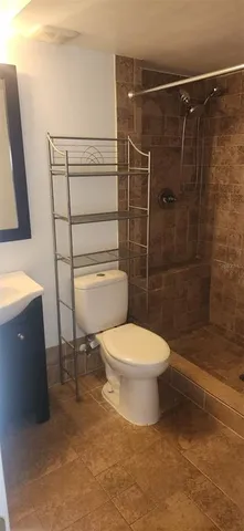 a bathroom with a toilet and a shower