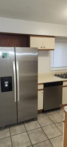 a kitchen with a refrigerator and a stove