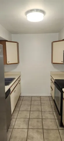 a kitchen with a cabinets and a stove top oven