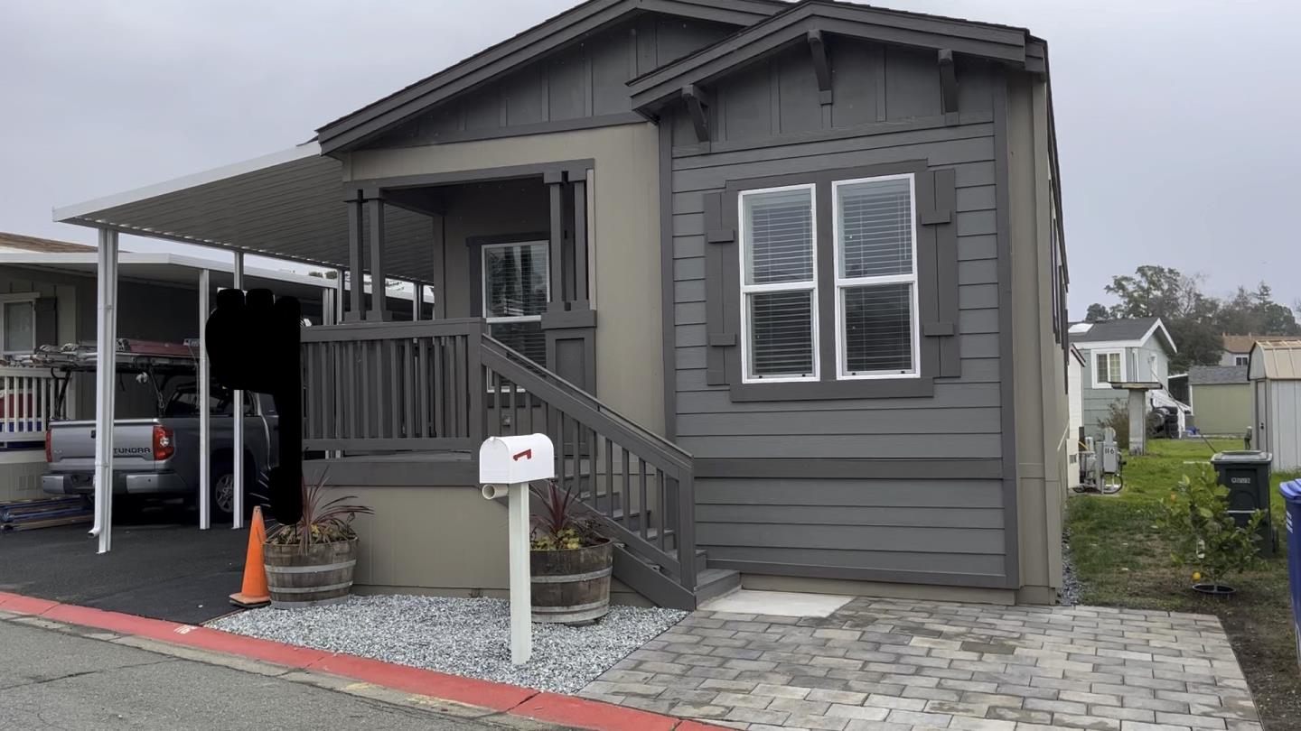 a view of a house with a door and wooden deck