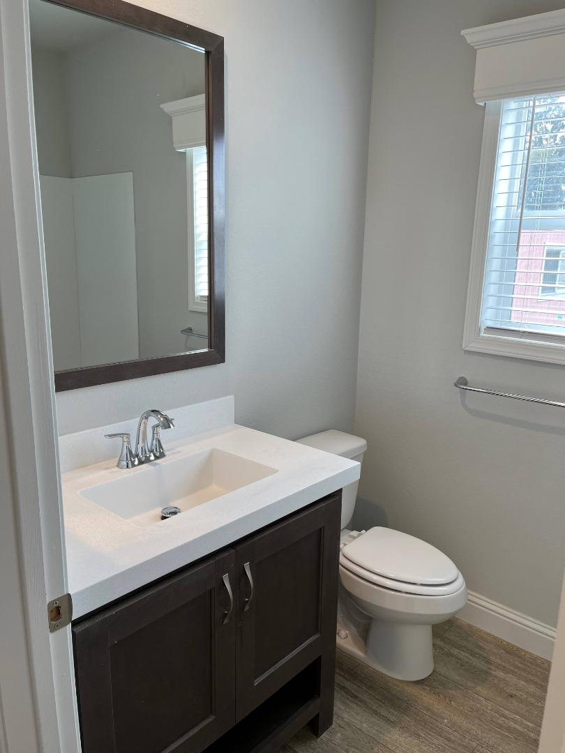116 A Street, Unit 116 Concord, CA 94520 - Photo 4 of 11 a bathroom with a sink a toilet and mirror
