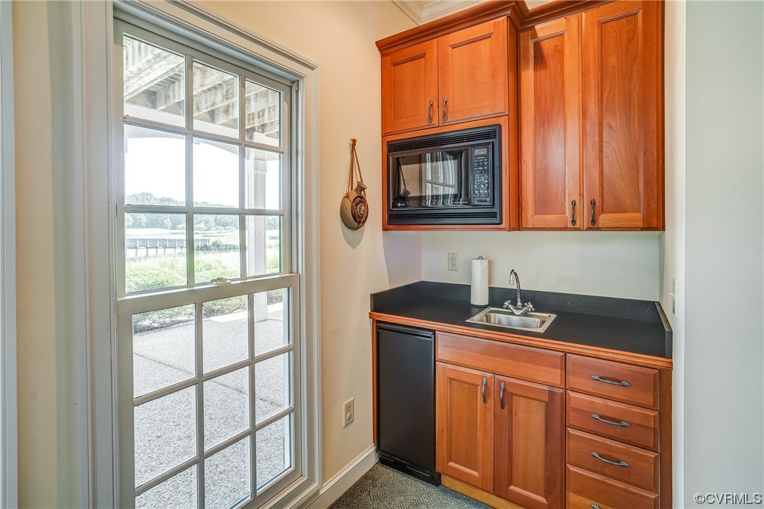 104 Longboat Williamsburg, VA 23188 - Photo 27 of 50 a kitchen with granite countertop cabinets stainless steel appliances a sink and a window