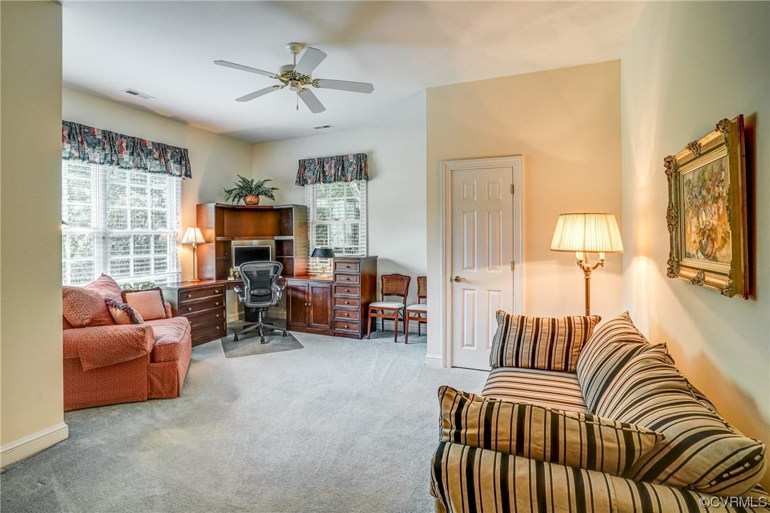104 Longboat Williamsburg, VA 23188 - Photo 33 of 50 a living room with furniture and a flat screen tv with a large window
