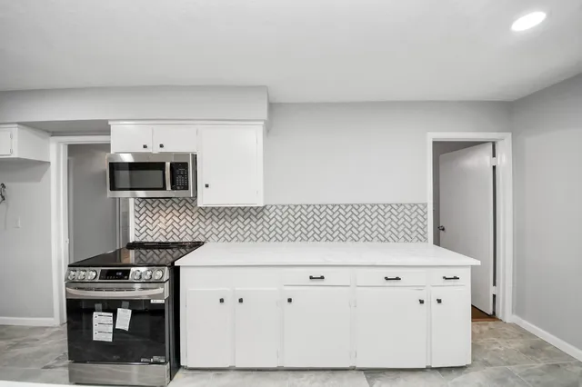 a kitchen with a stove and a microwave