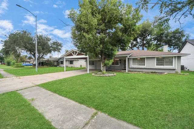 a front view of house with yard and green space