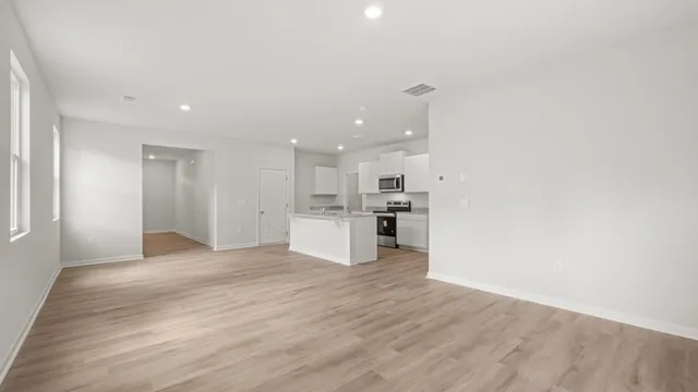 an empty room with closet and wooden floor