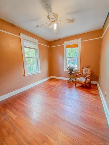 a view of livingroom with hardwood floor and ceiling fan