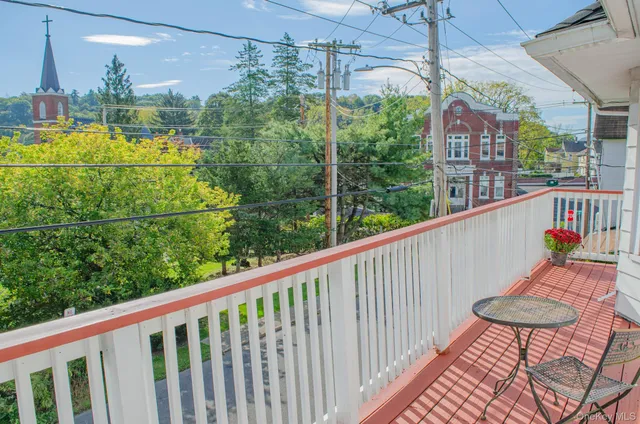 a view of a balcony with chairs