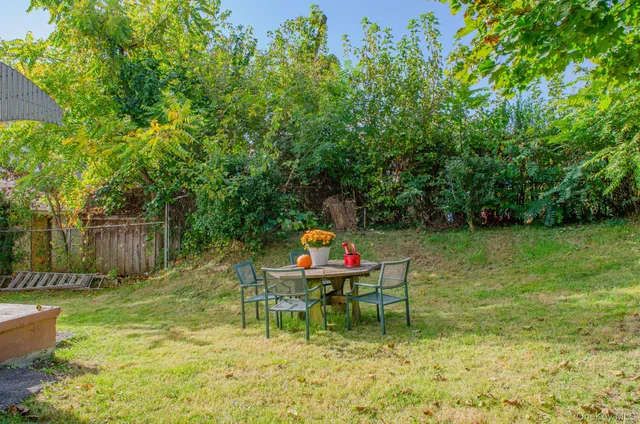 a backyard of a house with table and chairs