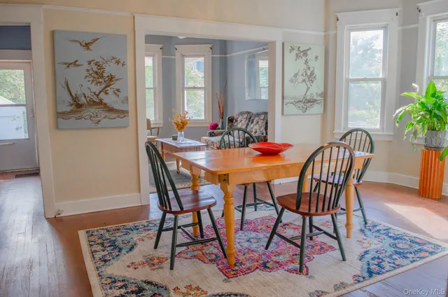 a dining room with furniture and wooden floor