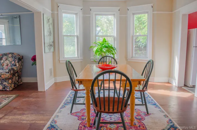 a view of a dining room with furniture and a potted plant
