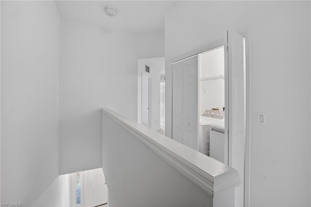 15995 Caldera Lane, Unit 69 Naples, FL 34110 - Photo 13 of 27 Corridor featuring washing machine and dryer