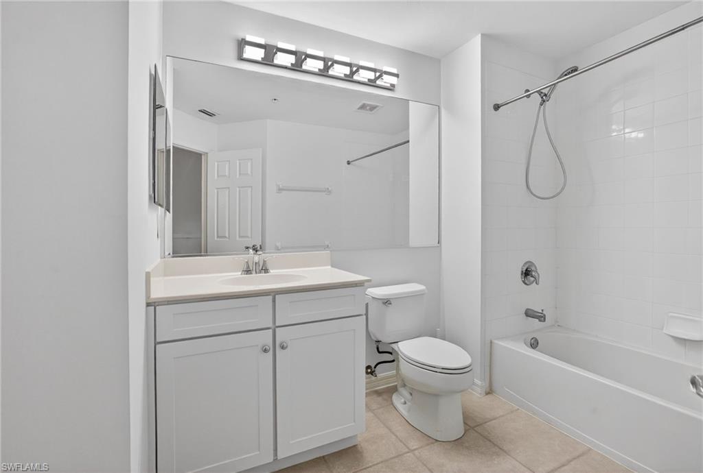 15995 Caldera Lane, Unit 69 Naples, FL 34110 - Photo 16 of 27 Bathroom with vanity, washtub / shower combination, and light tile patterned floors