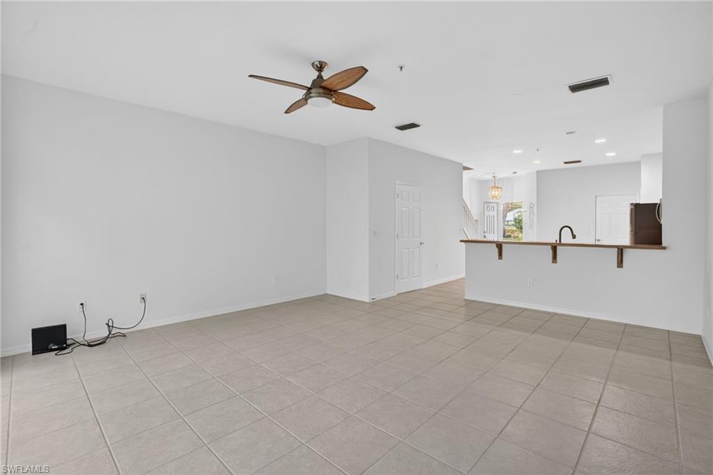 15995 Caldera Lane, Unit 69 Naples, FL 34110 - Photo 7 of 27 Unfurnished living room with a ceiling fan, light tile patterned flooring, and recessed lighting