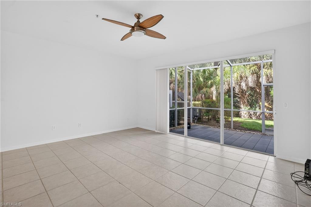 15995 Caldera Lane, Unit 69 Naples, FL 34110 - Photo 8 of 27 Empty room with a sunroom, ceiling fan, and light tile patterned flooring