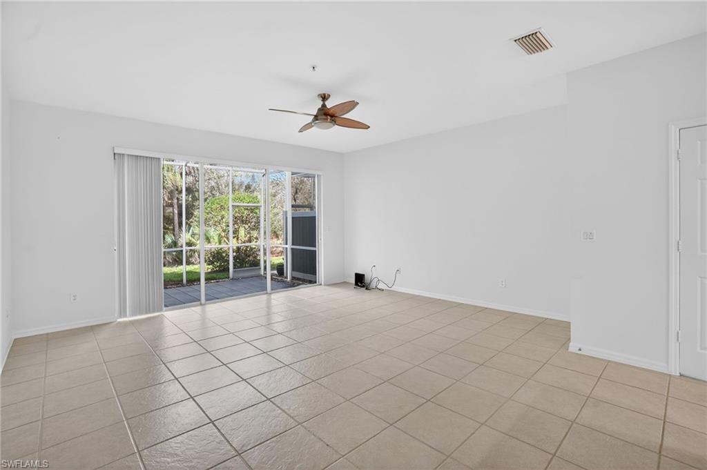 15995 Caldera Lane, Unit 69 Naples, FL 34110 - Photo 9 of 27 Empty room with a ceiling fan and light tile patterned floors