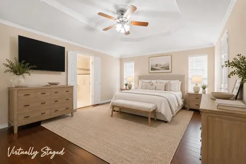 a bedroom with a large bed and a flat screen tv
