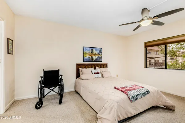 a bedroom with a bed and a window