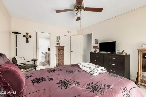 a bedroom with a bed and a flat screen tv