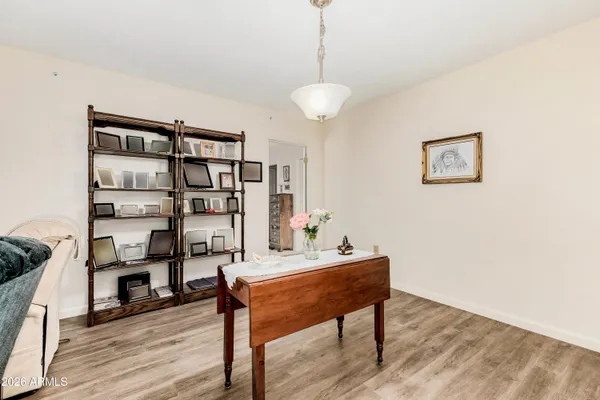 a view of a workspace with furniture and wooden floor