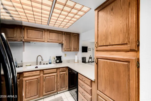 a kitchen with stainless steel appliances granite countertop a sink a stove and cabinets
