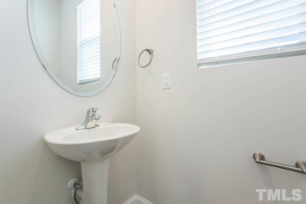 6913 Point Bar Place Raleigh, NC 27616 - Photo 11 of 23 a bathroom with a sink and a mirror