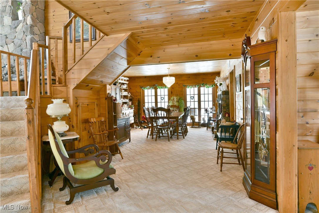 3339 Bushnell Campbell Road Fowler, OH 44418 - Photo 14 of 50 Dining area with light carpet, wooden ceiling, stairway, and wood walls