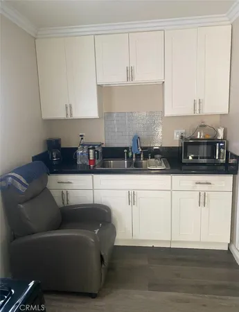 a kitchen with cabinets stainless steel appliances and a counter space