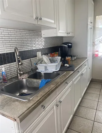 a kitchen with a sink and cabinets