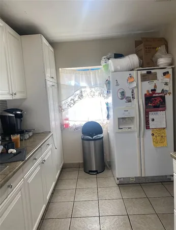a kitchen with a refrigerator and cabinets