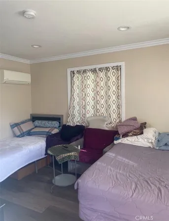 a bedroom with a bed windows and a piano