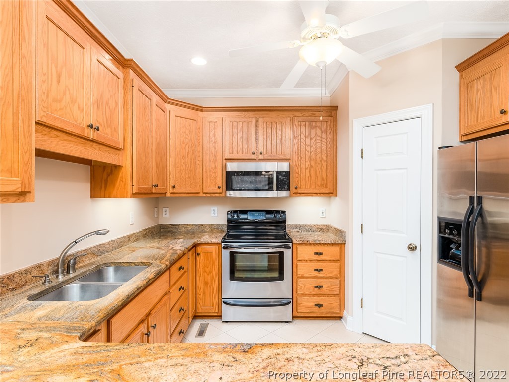 119 Myra Road Raeford, NC 28376 - Photo 18 of 43 a kitchen with stainless steel appliances granite countertop a stove a sink and a refrigerator