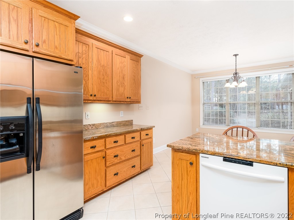 119 Myra Road Raeford, NC 28376 - Photo 19 of 43 a kitchen with stainless steel appliances granite countertop a sink a stove and a refrigerator