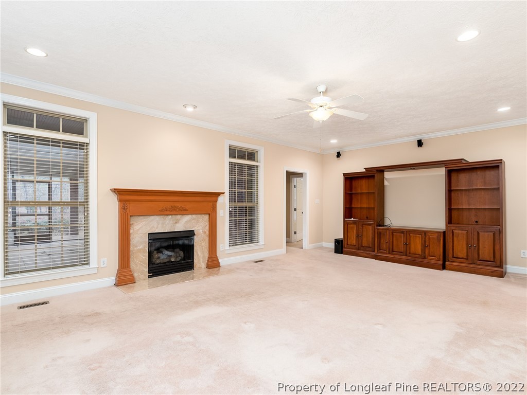 119 Myra Road Raeford, NC 28376 - Photo 23 of 43 a view of an empty room with a fireplace and a window