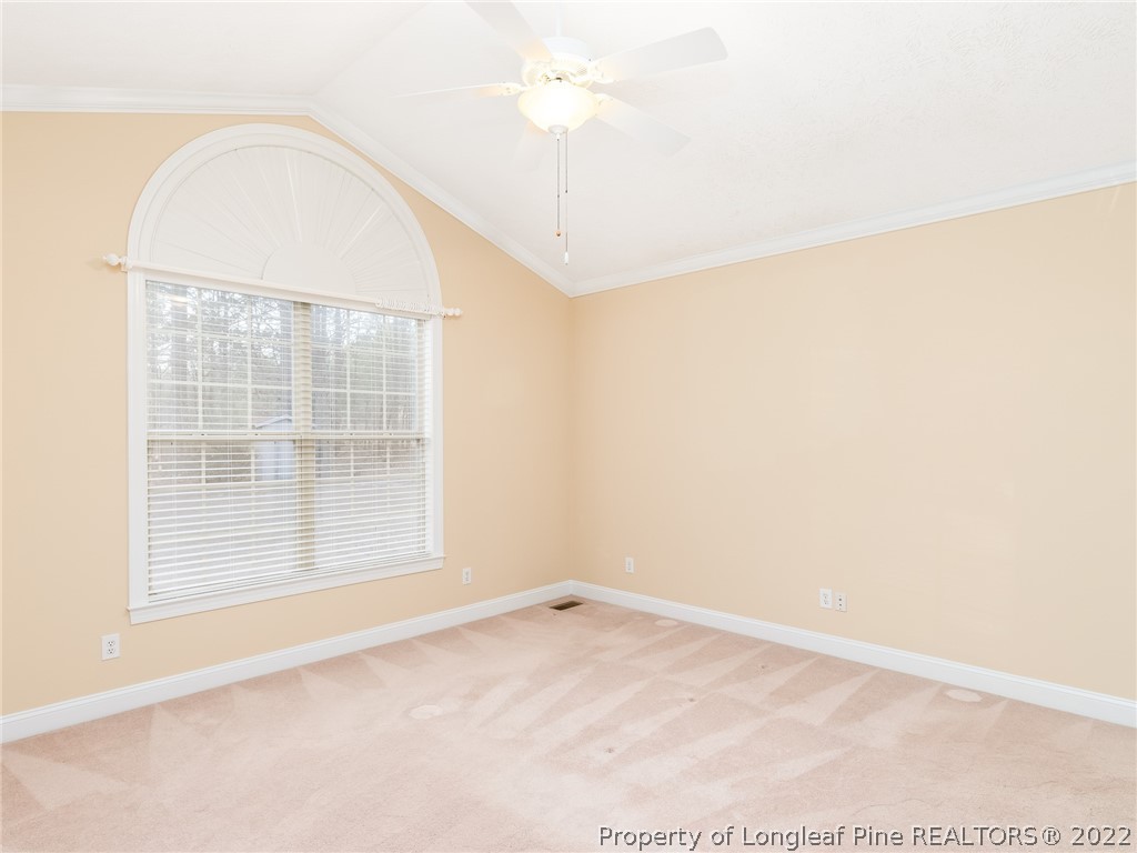119 Myra Road Raeford, NC 28376 - Photo 25 of 43 an empty room with a chandeliers fan