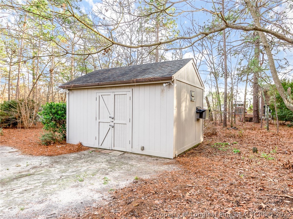119 Myra Road Raeford, NC 28376 - Photo 41 of 43 a view of a wooden house with a large tree