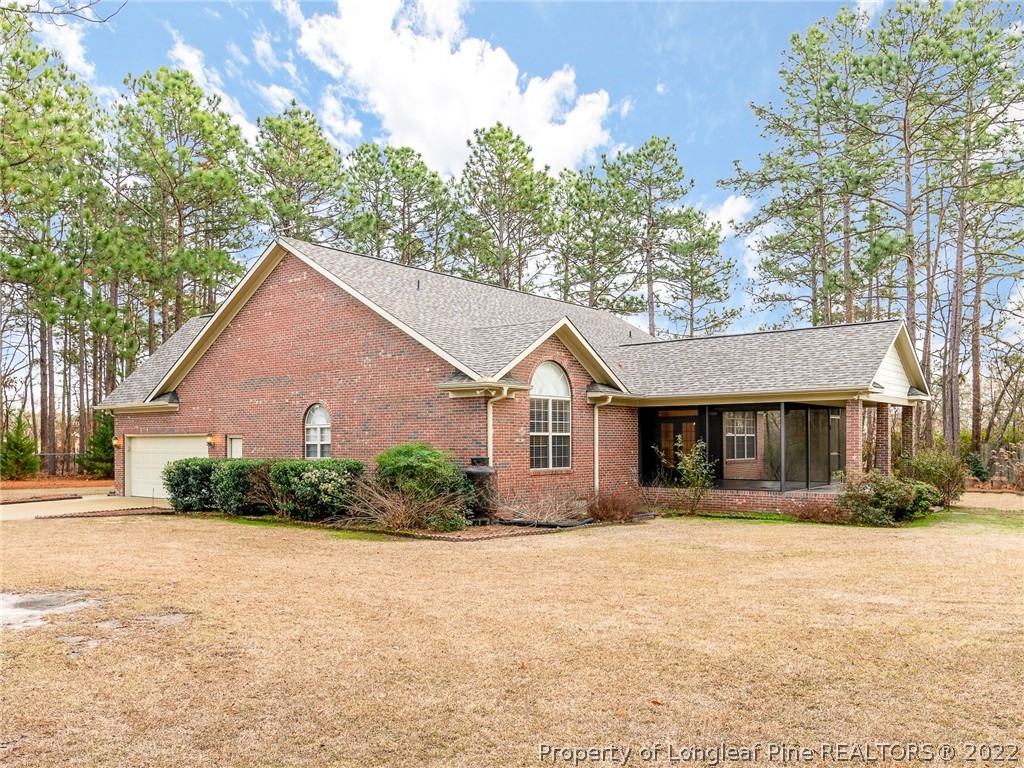119 Myra Road Raeford, NC 28376 - Photo 6 of 43 a front view of house with yard and trees around
